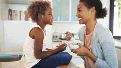 Mother and daughter eating breakfast and discussing the side effects of her ADHD medication
