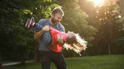 A dad plays outside with his daughter with ADHD to expend extra energy and avoid a meltdown.