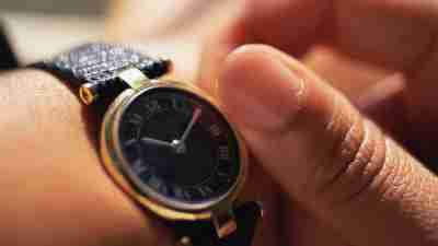 Close up of person with ADHD adjusting their wrist watch to better manage their time