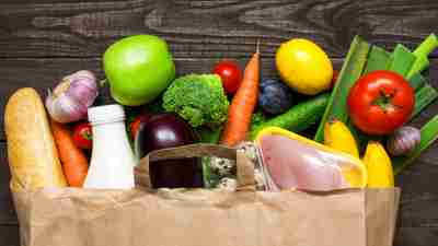 Healthy foods for ADHD brains spilling out of a paper grocery bag