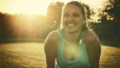 A woman smiling after a run, one of many natural treatments for ADHD in adults