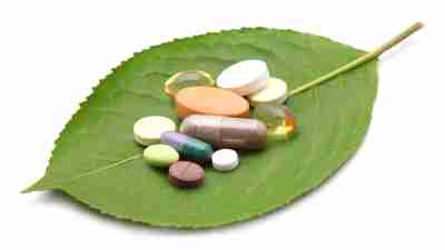Some of the best supplements for ADHD sitting on a green leaf